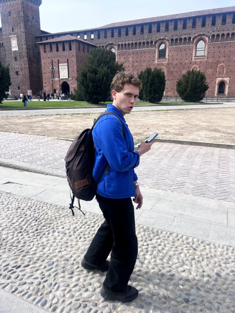 Arc Media crew member walking through the courtyard of Sforza Castle in Milan