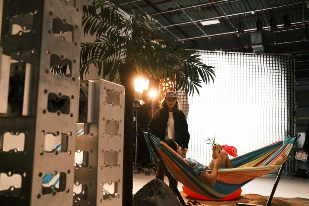 Talent relaxing in the hammock on the beach set with the rig behind