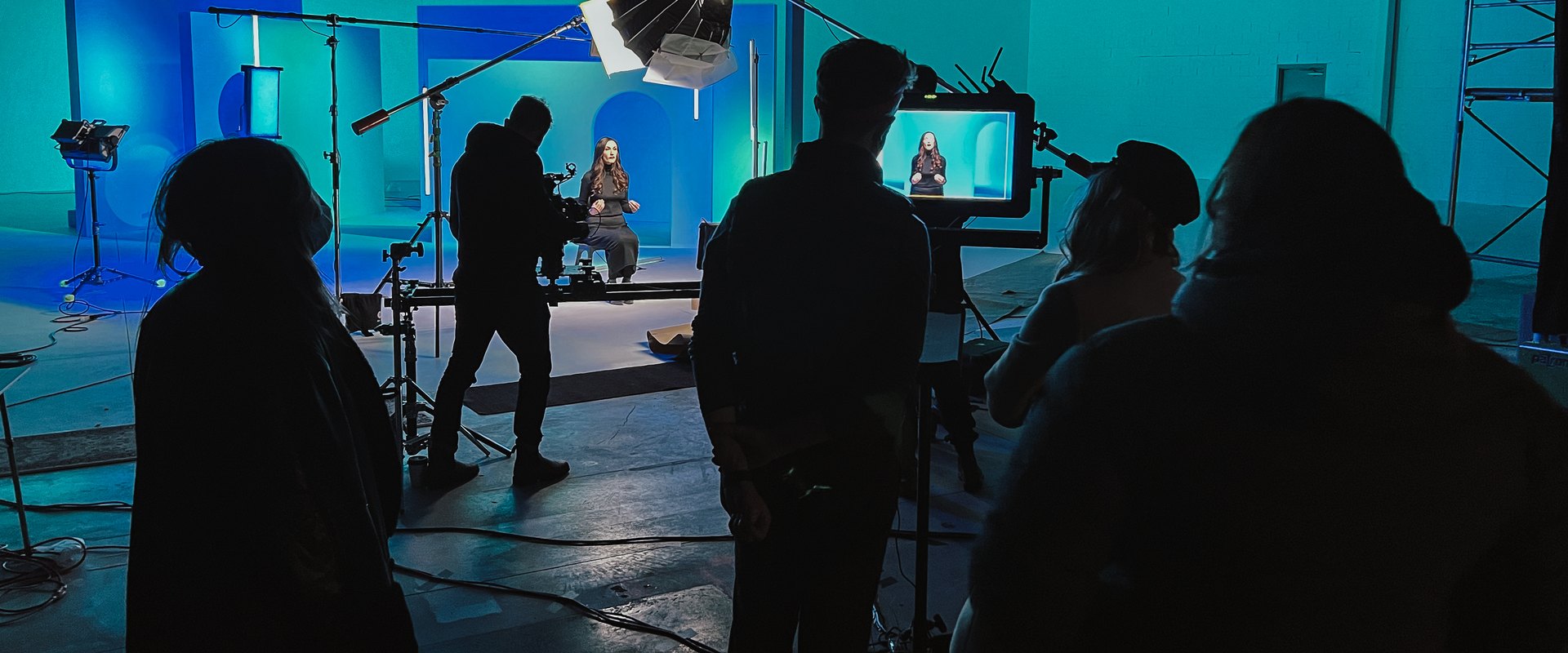 Crew silhouettes on a blue studio day
