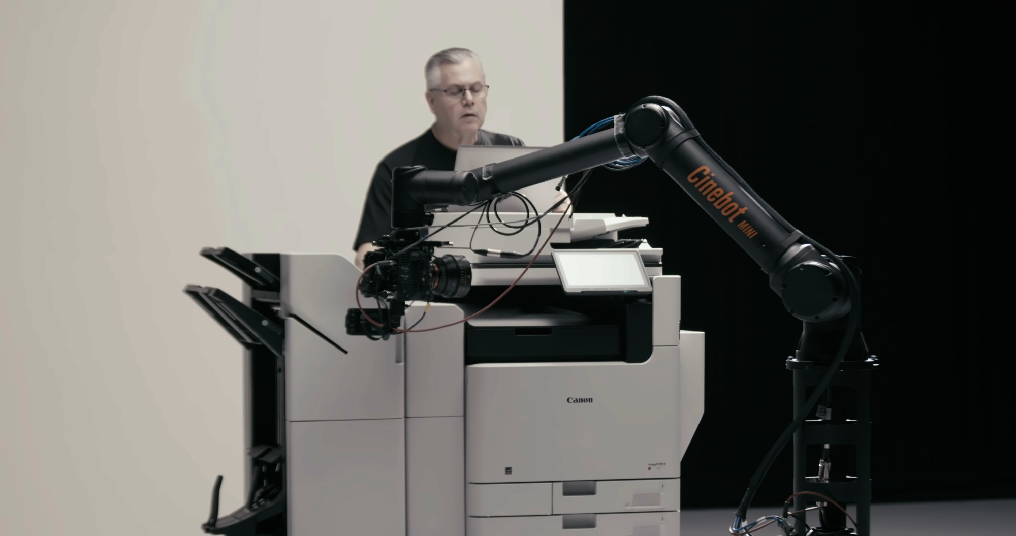 The Cinebot Mini positioned over a Canon imageFORCE printer on the studio floor