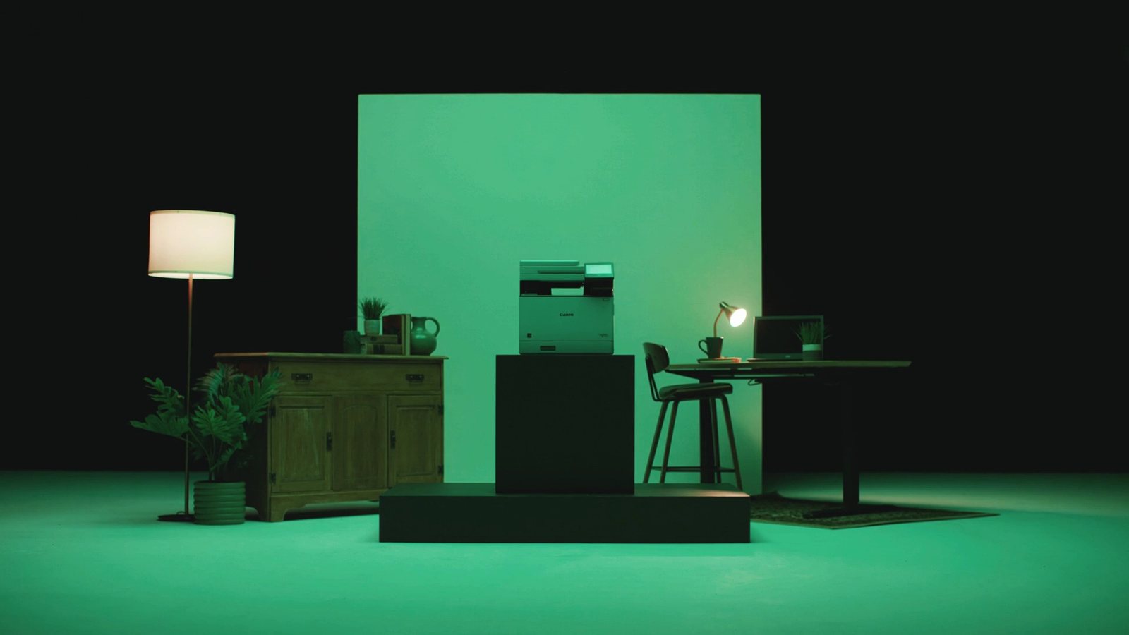 The printer in a green-lit office environment