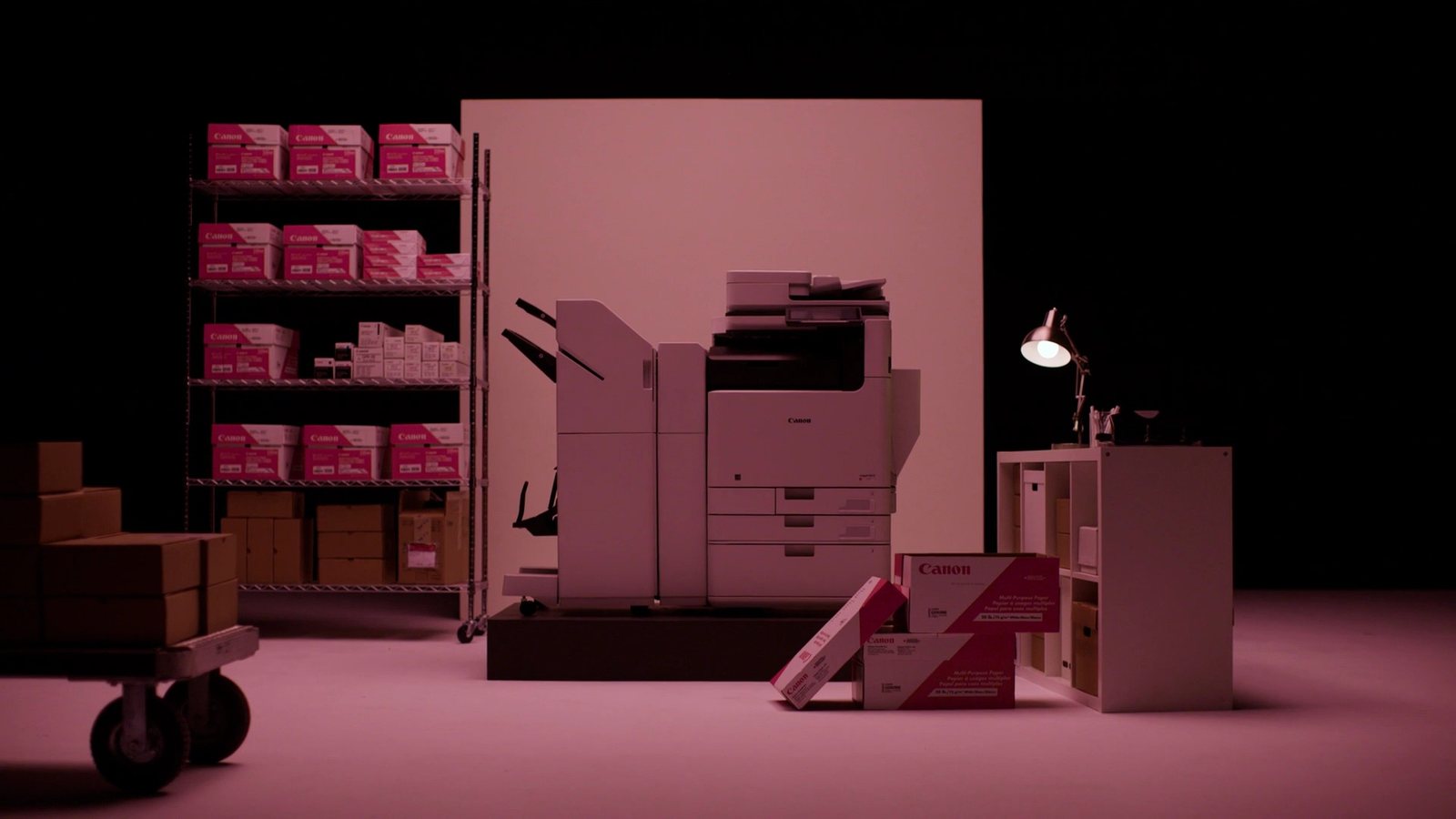 The printer in a pink-lit office environment